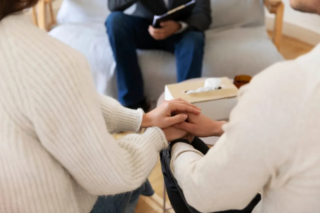 A couple attentively consults with a financial advisor, discussing estate planning strategies amid the complexities of remarriage. The image highlights the importance of protecting assets, updating beneficiaries, and ensuring a seamless transition for loved ones.
